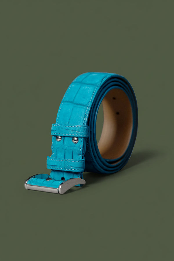 Turquoise leather belt with silver buckle on a white background