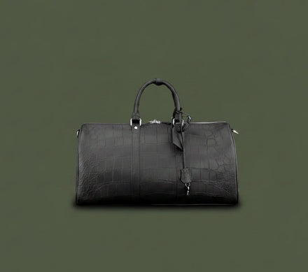 Load image into Gallery viewer, Black leather duffel bag on a dark green background