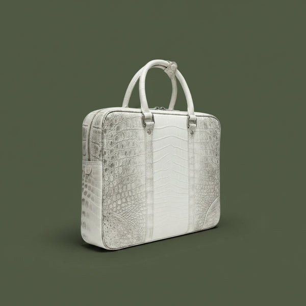 White crocodile-patterned handbag on a dark green background