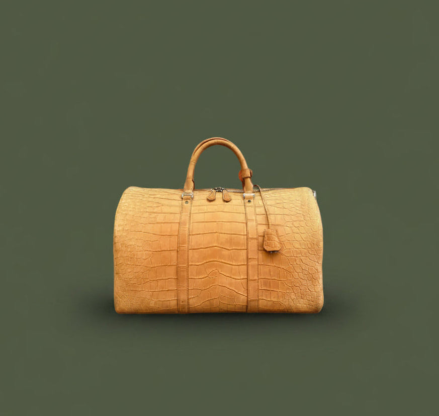 Brown leather duffel bag on a green background